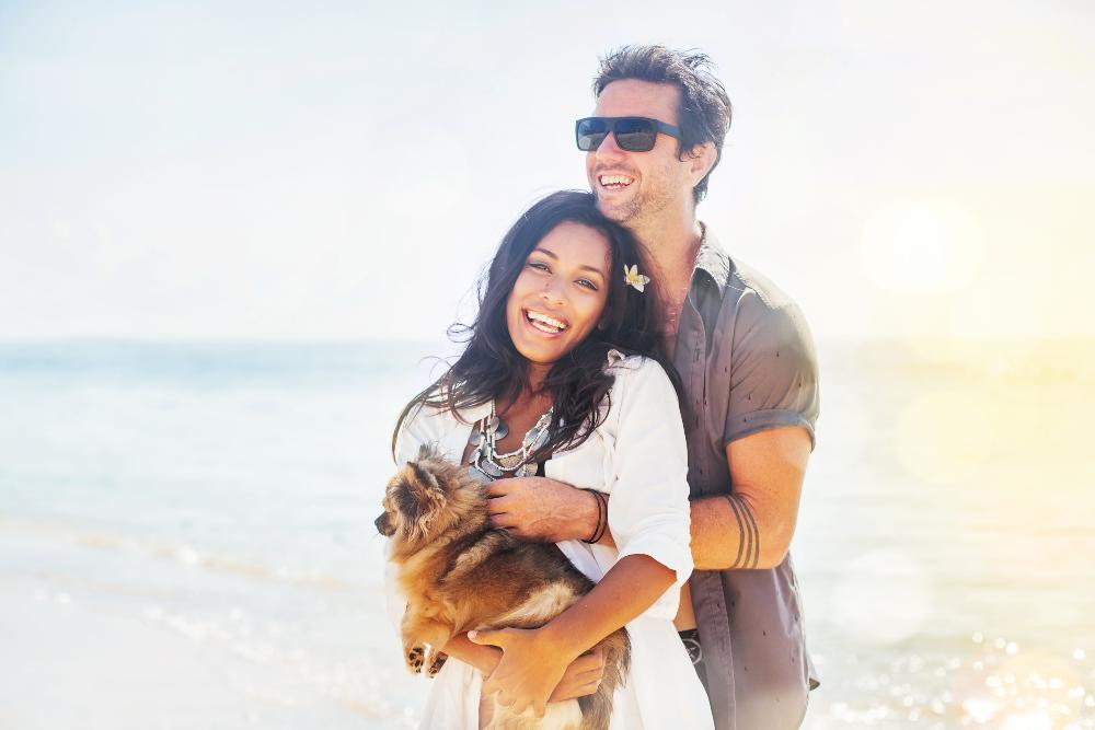 Couple smiling on beach | Warners Bay Dentist