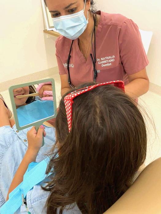 Dr Nathalia Garritano with a young patient