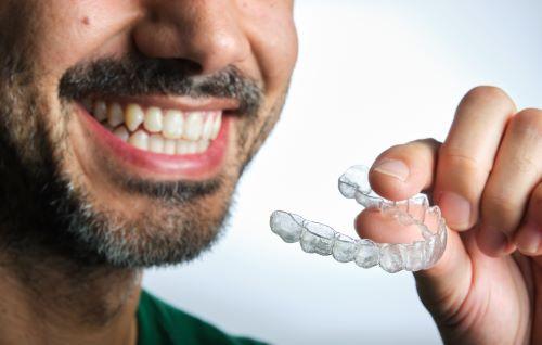 close up of man holding invisalign in warners bay