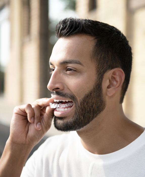 man putting in invisalign tray in warners bay
