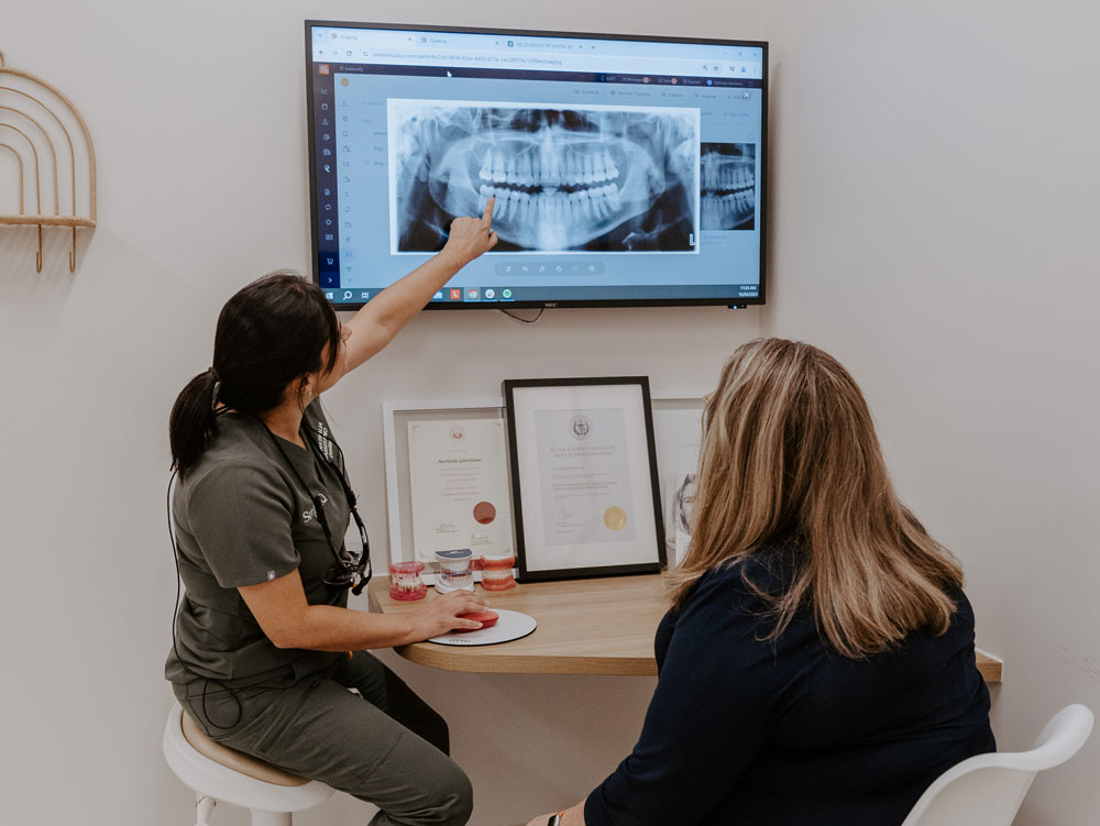 patient being shown digital xrays by warners bay dentist