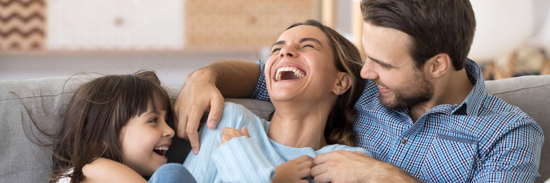 warners bay Family laughing on couch 