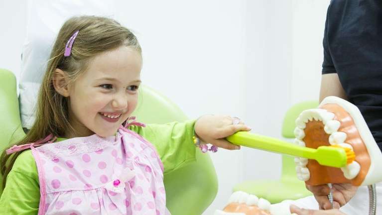 young girl smiling in dental chair in warners bay