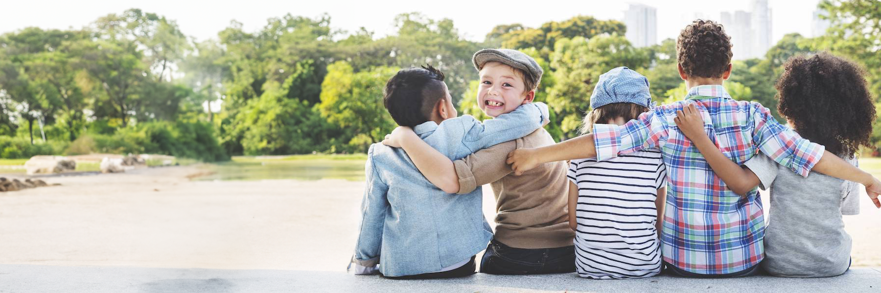 group of kids with one boy turning back to camera and smiling
