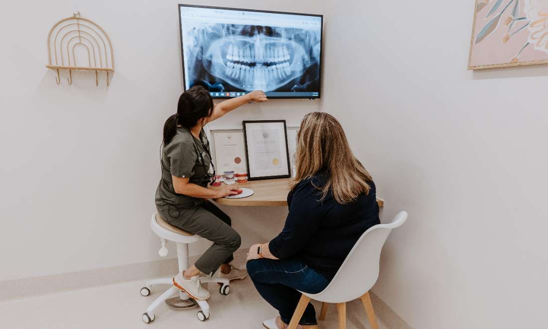 dentist showing a patient their digital xrays