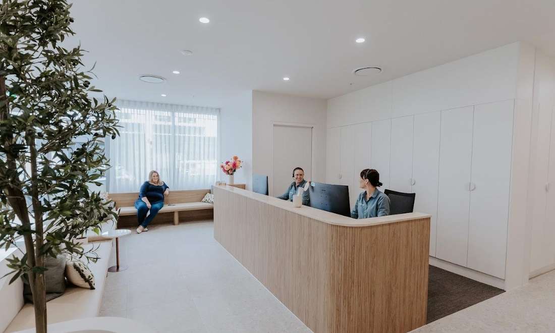 front desk staff and patient at SmilesHQ