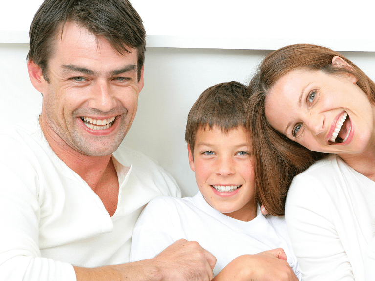 mom, dad, and son smiling